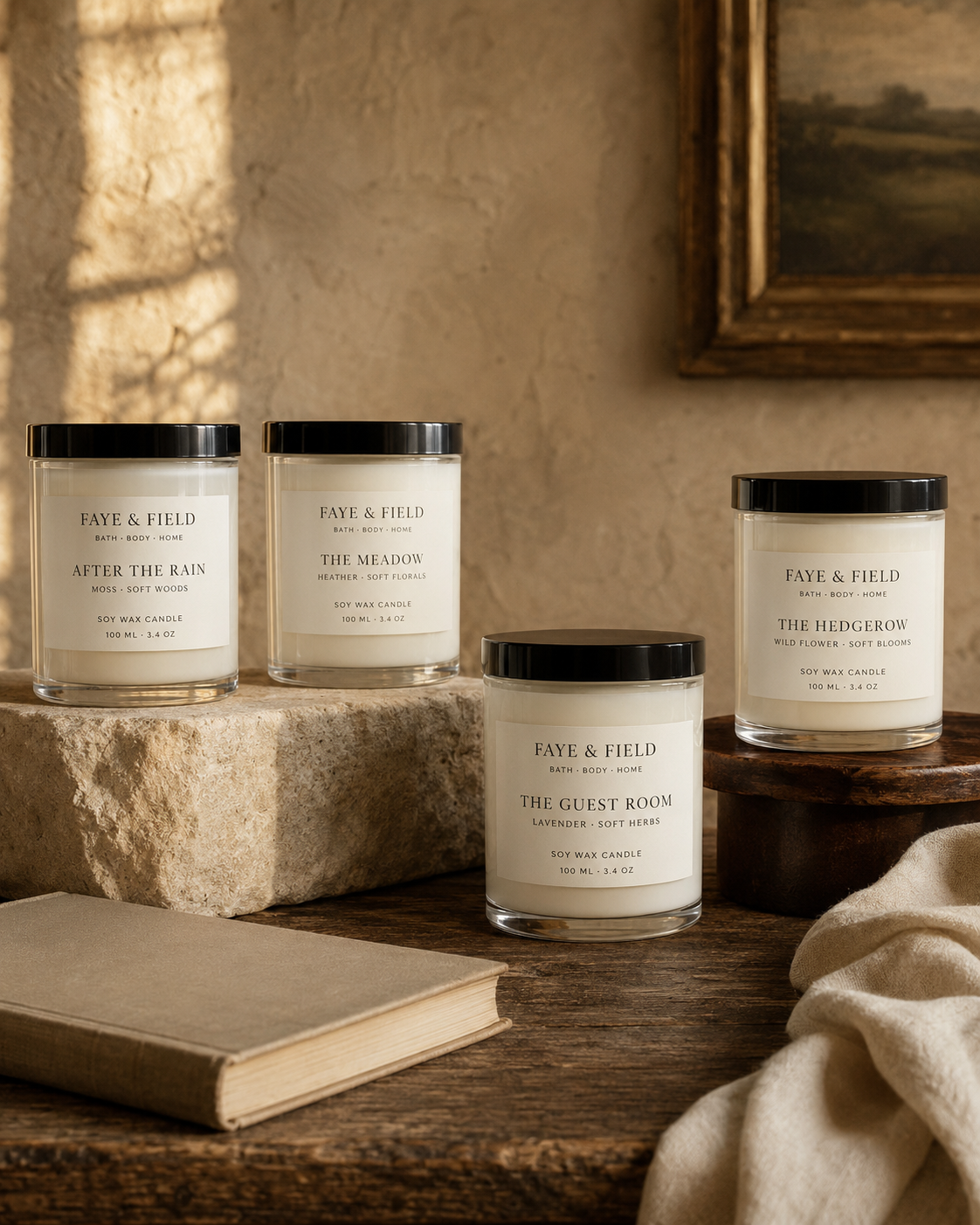 Four Faye & Field soy wax candles arranged in a warm British country-house interior.